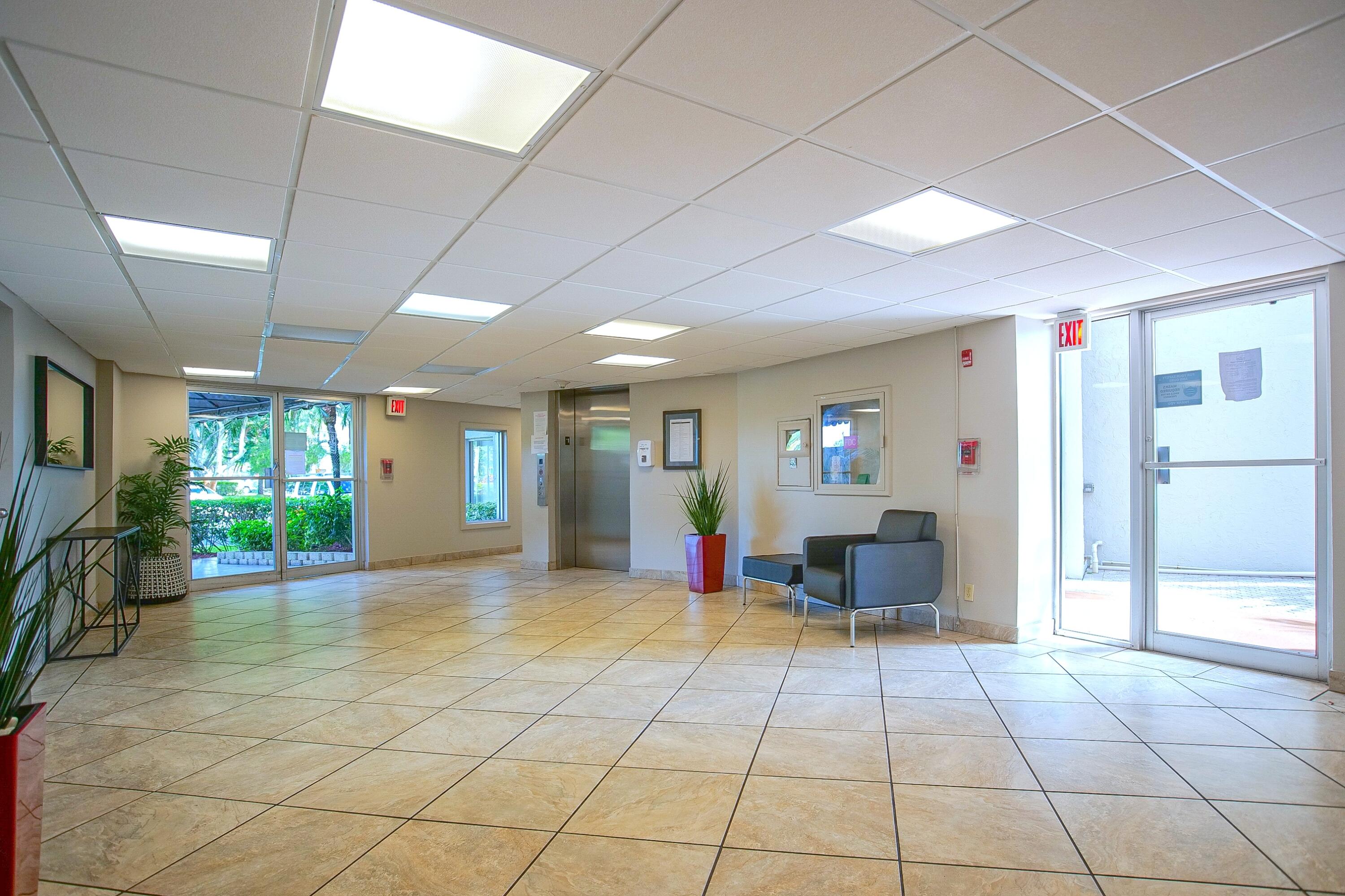 3930 Inverrary Boulevard, Unit 703D Lauderhill, FL 33319 - Photo 52 of 62 a view of a lobby with furniture and floor to ceiling window
