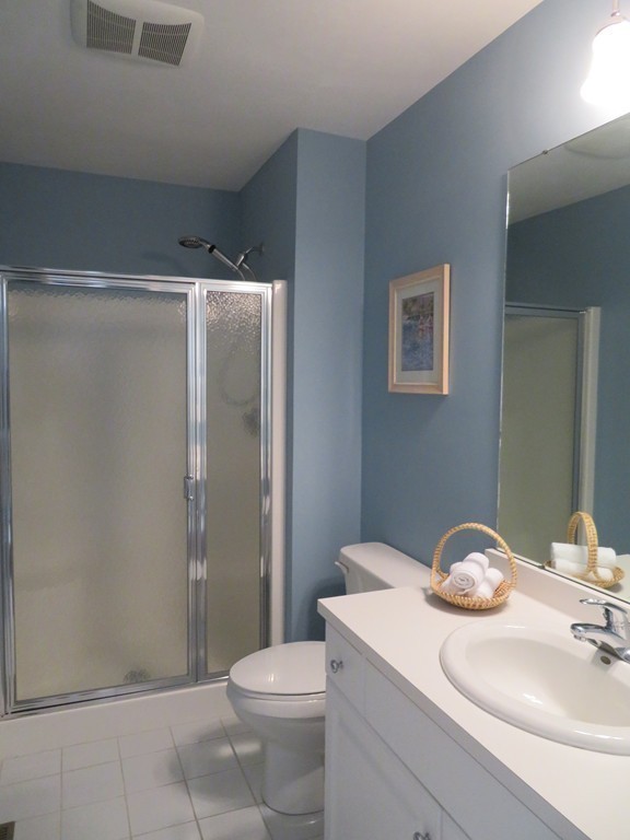 7 Strawberry Lane, Unit A Hudson, MA 01749 - Photo 14 of 20 a bathroom with a granite countertop sink toilet and shower