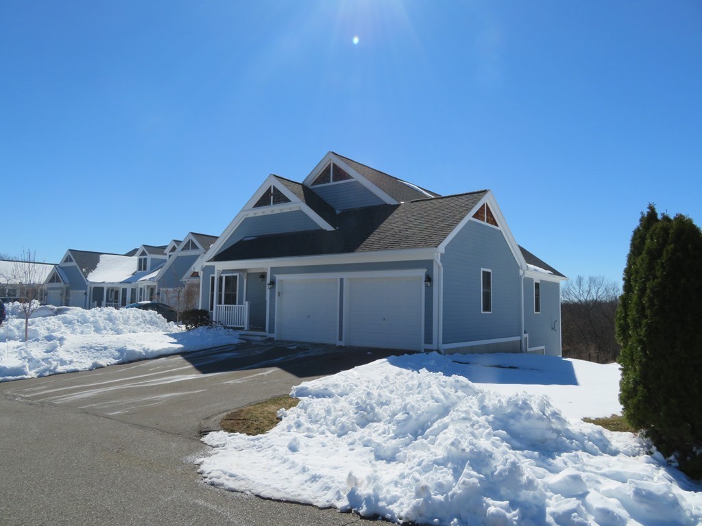 7 Strawberry Lane, Unit A Hudson, MA 01749 - Photo 20 of 20 a front view of a house with a yard