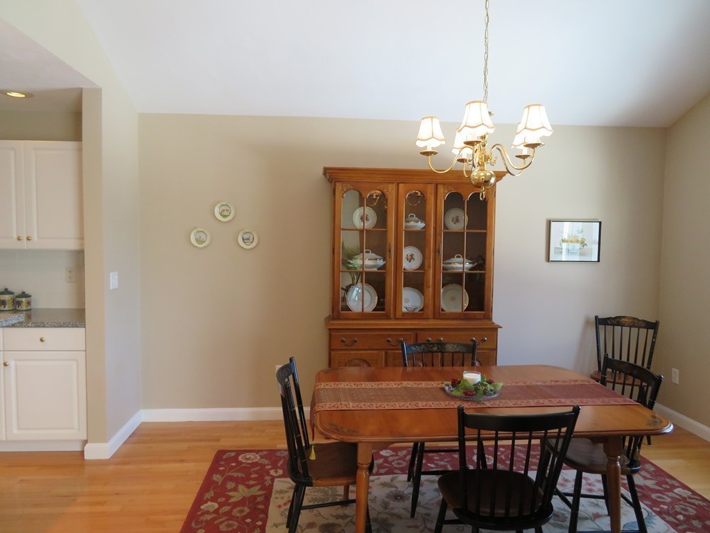 7 Strawberry Lane, Unit A Hudson, MA 01749 - Photo 6 of 20 a view of a dining room with furniture and chandelier
