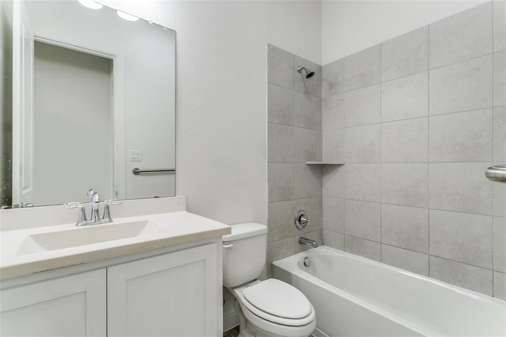 523 Paddock Way Irving, TX 75039 - Photo 11 of 23 a bathroom with a bathtub shower sink vanity mirror and toilet