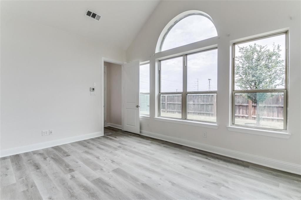 523 Paddock Way Irving, TX 75039 - Photo 13 of 23 an empty room with wooden floor and windows