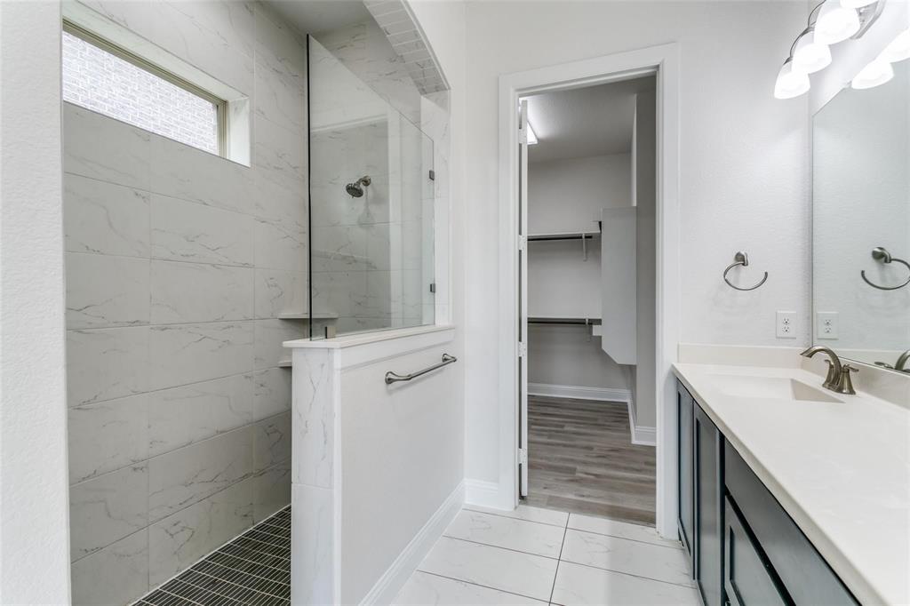 523 Paddock Way Irving, TX 75039 - Photo 14 of 23 a bathroom with a sink and a mirror