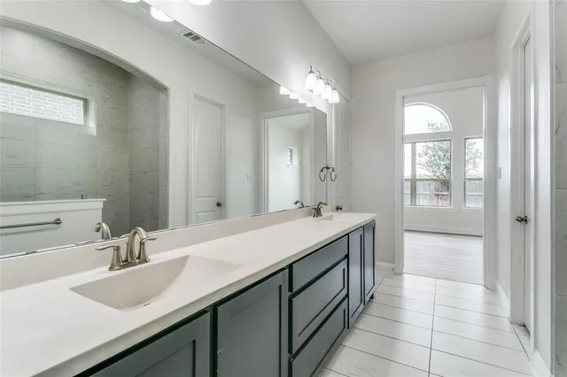 a bathroom with a sink double vanity and a mirror