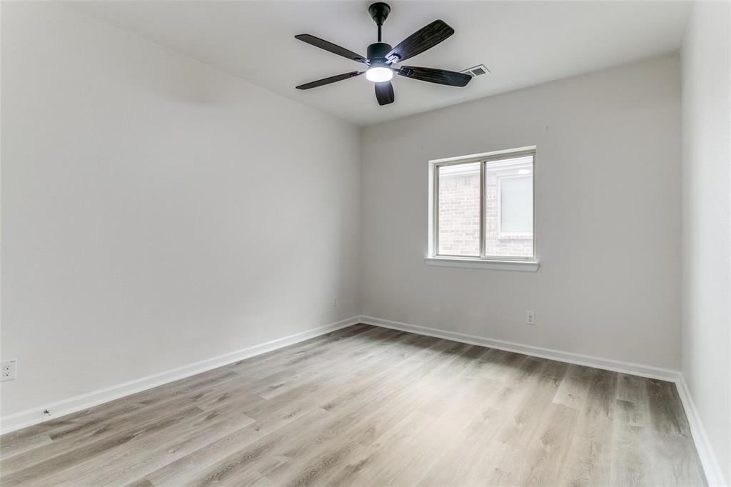 523 Paddock Way Irving, TX 75039 - Photo 17 of 23 an empty room with a window and a fan