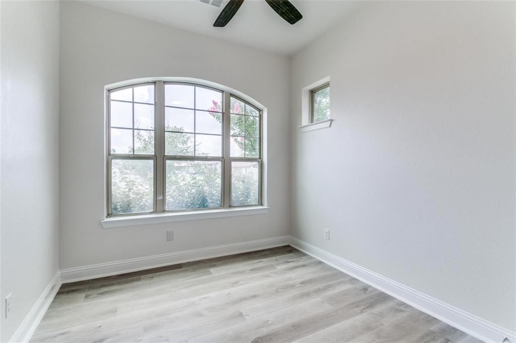 523 Paddock Way Irving, TX 75039 - Photo 18 of 23 an empty room with windows and fan
