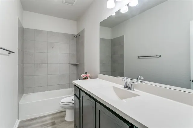 a bathroom with a sink a toilet and bathtub