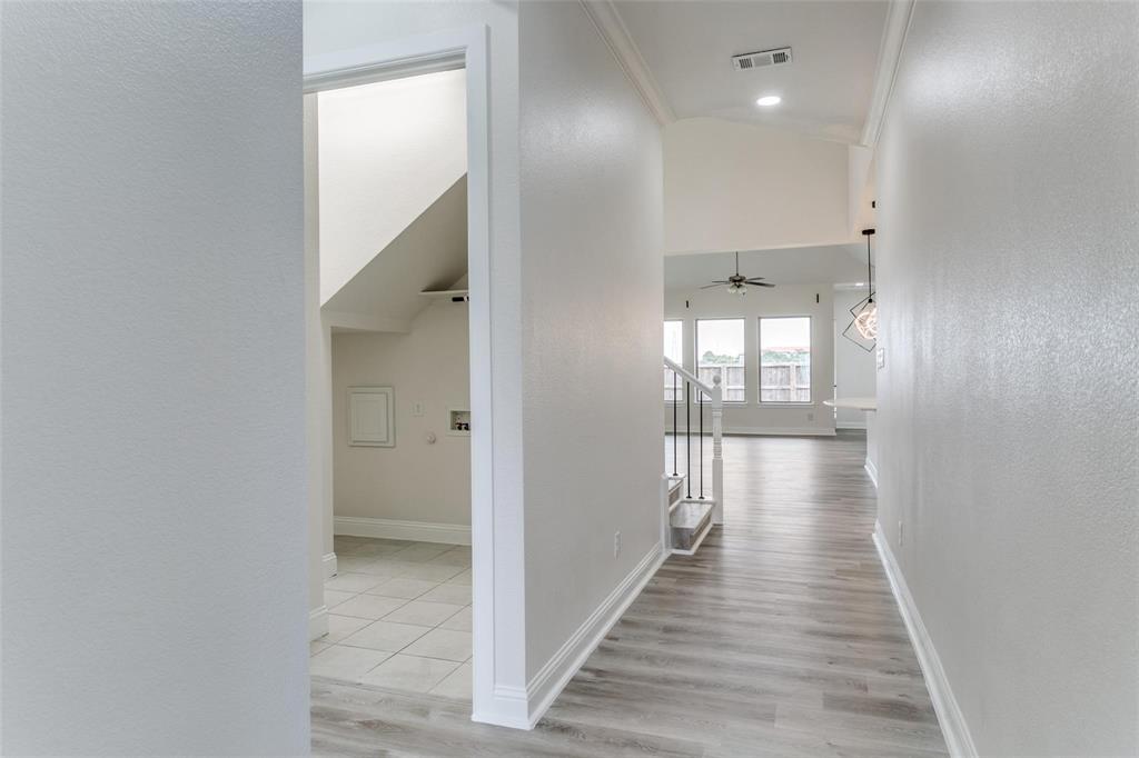 523 Paddock Way Irving, TX 75039 - Photo 2 of 23 a view of a hallway with wooden floor and a bathroom