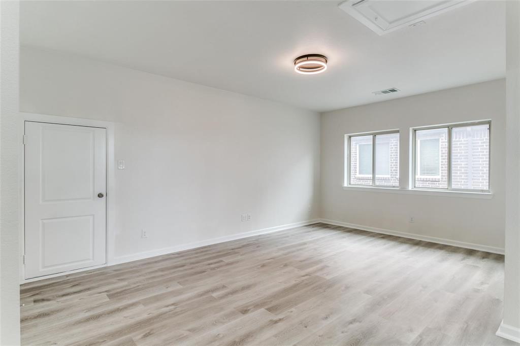 523 Paddock Way Irving, TX 75039 - Photo 21 of 23 a view of an empty room with wooden floor and a window