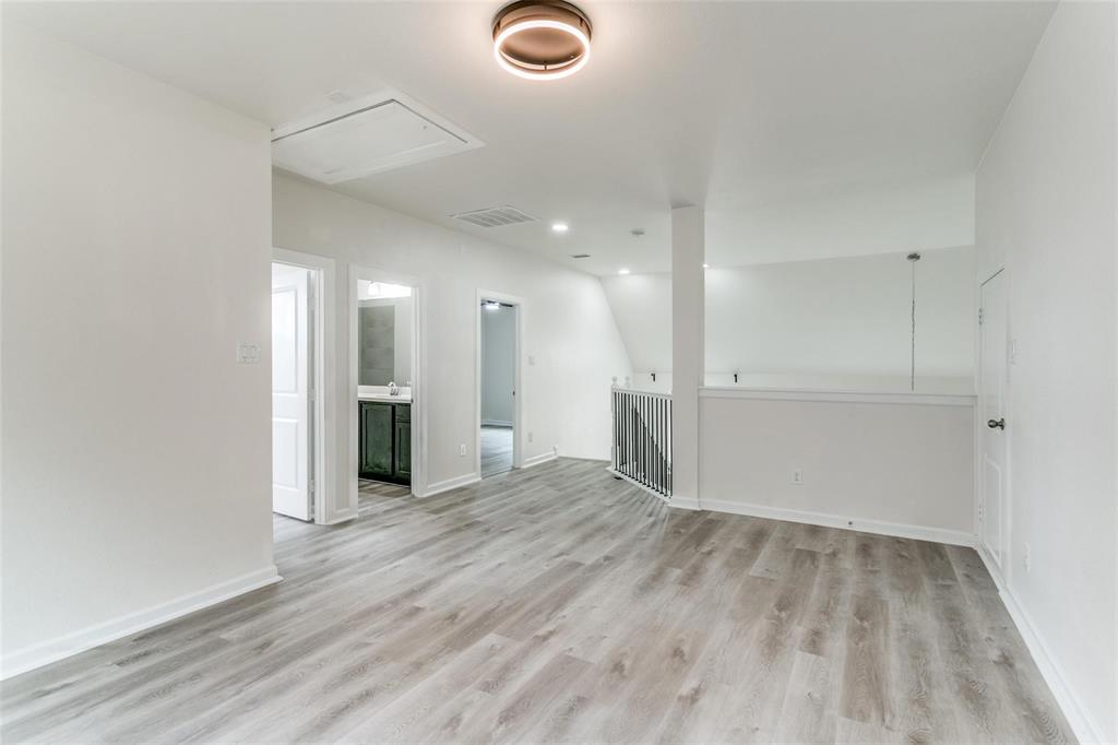 523 Paddock Way Irving, TX 75039 - Photo 22 of 23 a view of an empty room with wooden floor