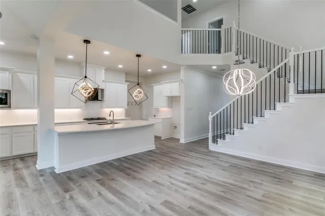 a kitchen with counter top space and a view of living room