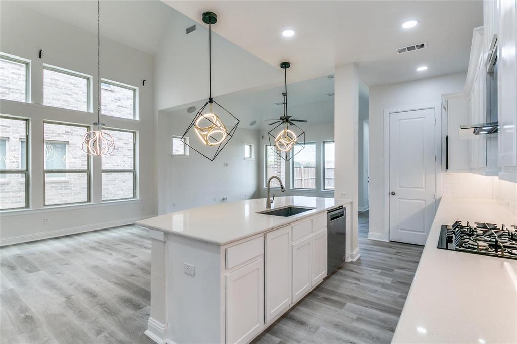 523 Paddock Way Irving, TX 75039 - Photo 8 of 23 a large white kitchen with a large window a sink and stainless steel appliances