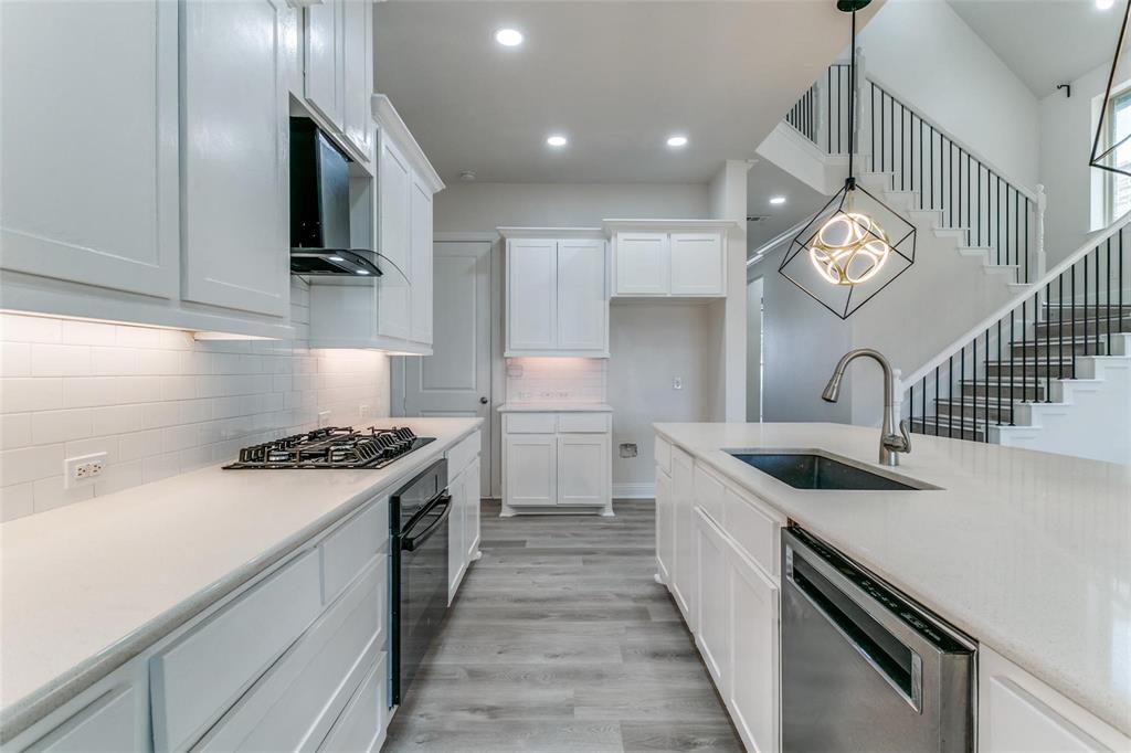 523 Paddock Way Irving, TX 75039 - Photo 10 of 23 a kitchen with a sink and a stove top oven