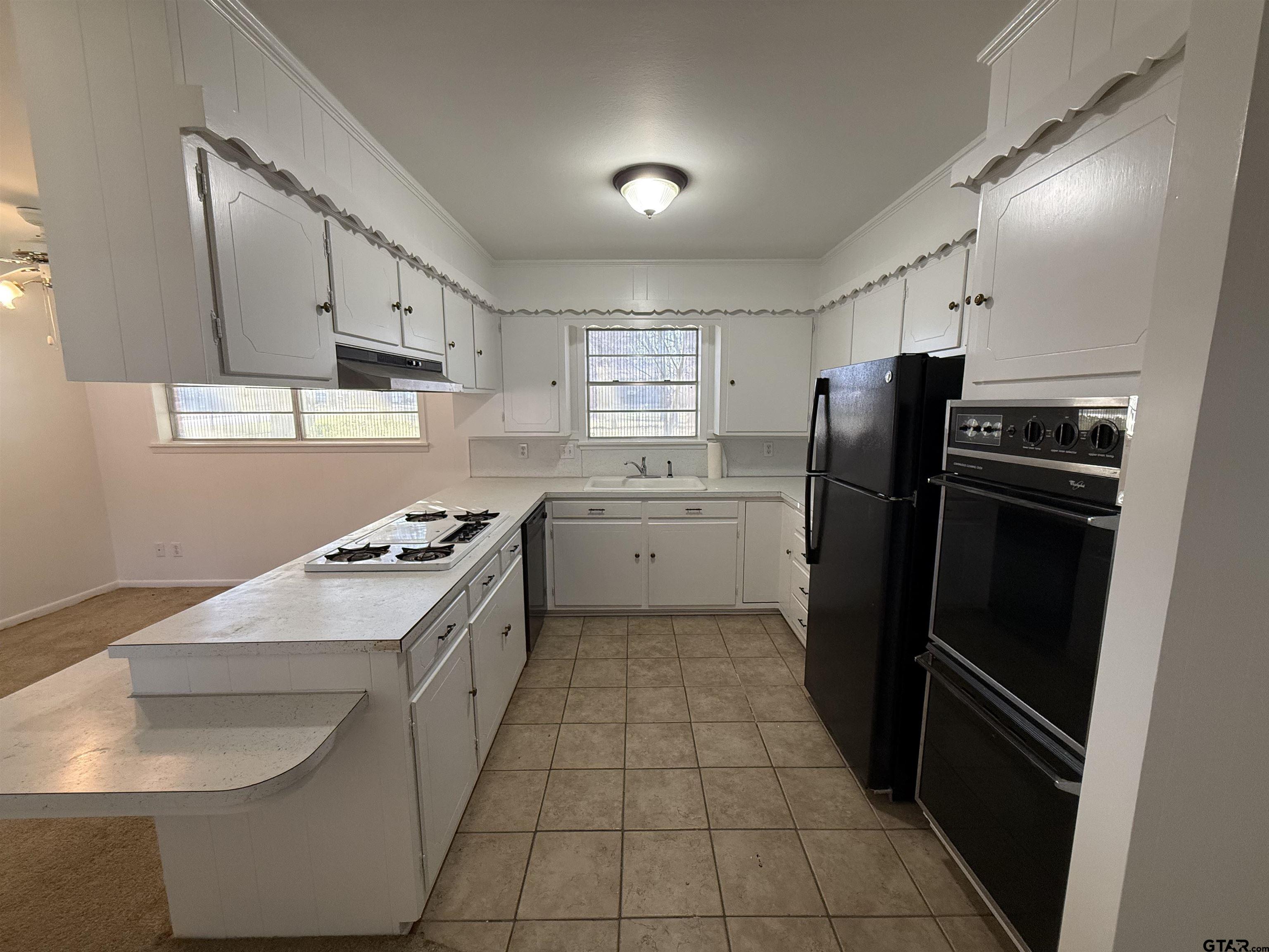 1785 Rollin Road Canton, TX 75103 - Photo 5 of 12 a kitchen with a sink a refrigerator and a stove