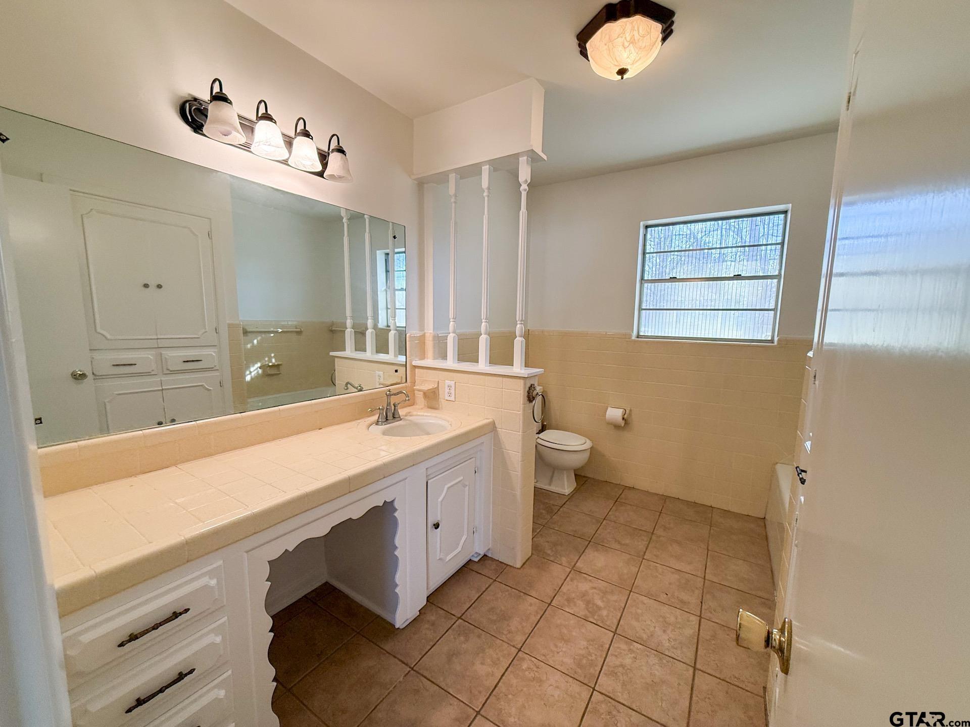 1785 Rollin Road Canton, TX 75103 - Photo 8 of 12 a spacious bathroom with a double vanity sink a mirror and a toilet