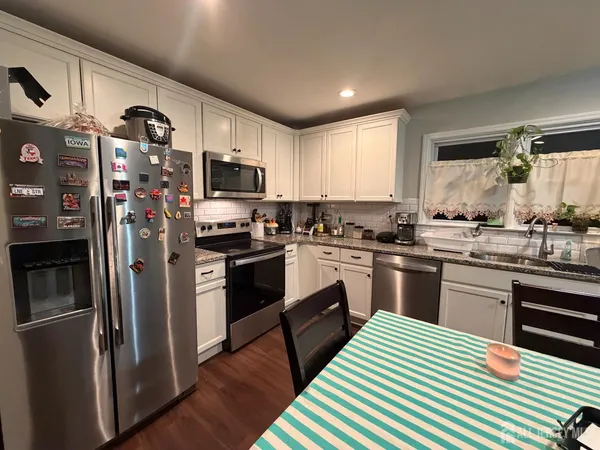 a kitchen with a sink stainless steel appliances and cabinets