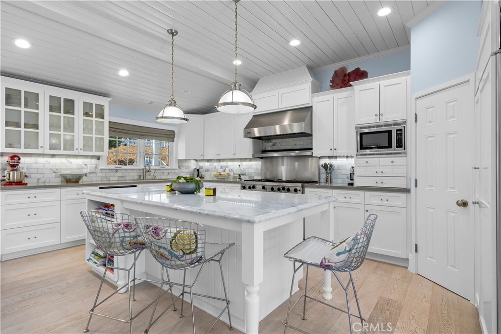 5215 Middlecrest Road Rancho Palos Verdes, CA 90275 - Photo 20 of 53 a kitchen with stainless steel appliances granite countertop a white cabinets and chairs