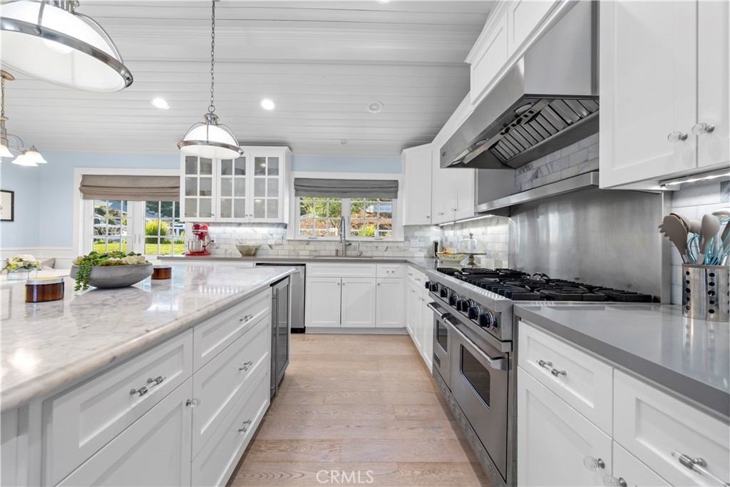 5215 Middlecrest Road Rancho Palos Verdes, CA 90275 - Photo 22 of 53 a kitchen with stainless steel appliances granite countertop a sink a stove and cabinets