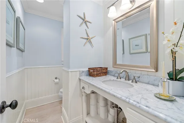 a bathroom with a granite countertop sink a mirror and shower