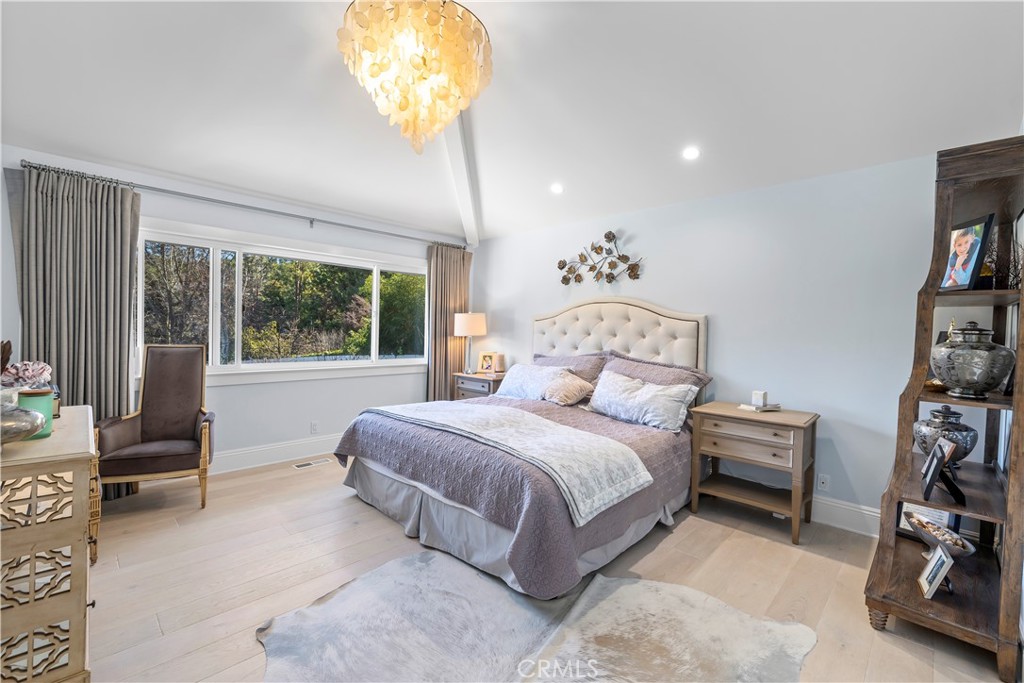 5215 Middlecrest Road Rancho Palos Verdes, CA 90275 - Photo 8 of 53 a bedroom with a bed and a chandelier
