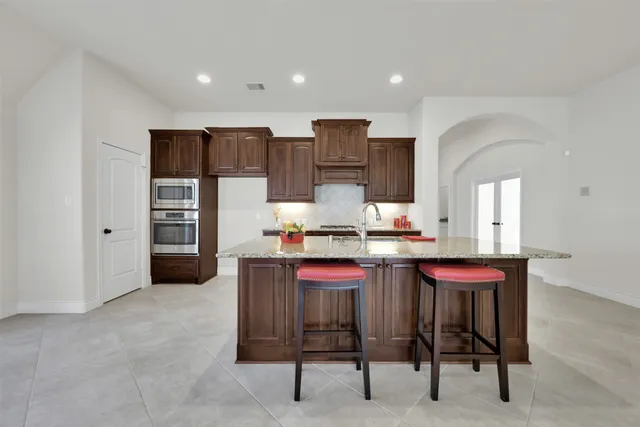 a kitchen with a sink cabinets and wooden floor