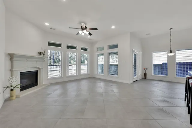 a view of an empty room with a fireplace and a window