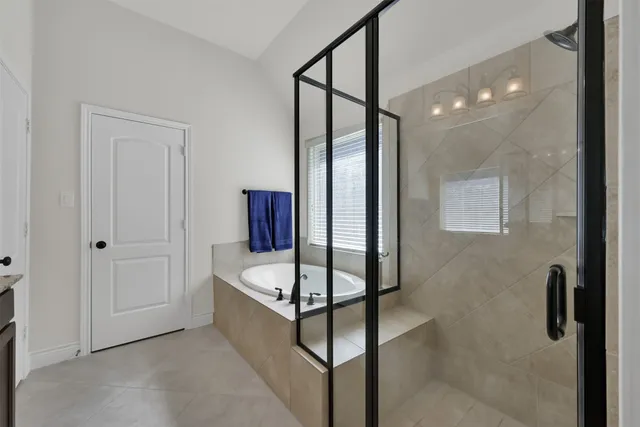 a bathroom with a tub and shower