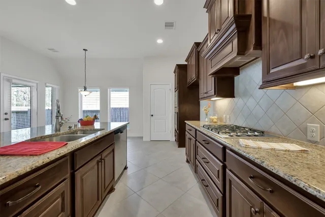 a kitchen that has a sink and a stove