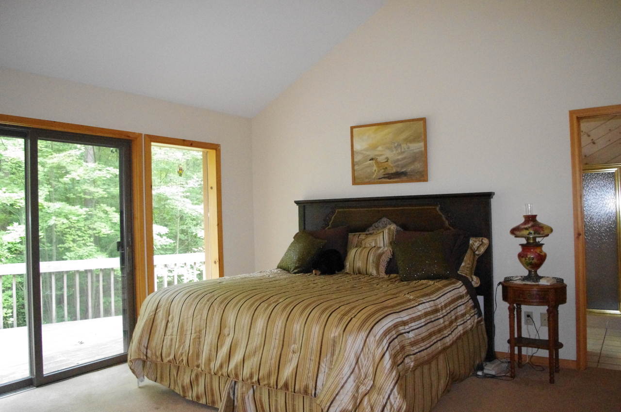 106 Stevens Lake Road Monterey, MA 01245 - Photo 13 of 16 a bedroom with a bed and window