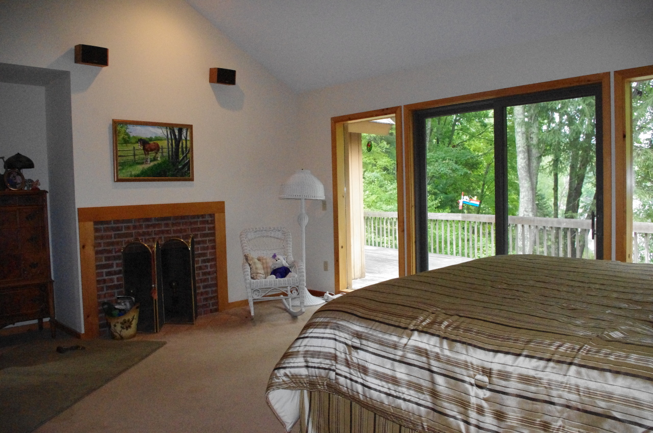 106 Stevens Lake Road Monterey, MA 01245 - Photo 15 of 16 a bedroom with a bed and a fireplace