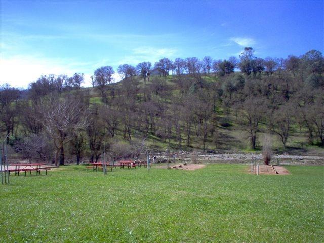 2098 Quail Hill Road Copperopolis, CA 95228 - Photo 24 of 24 a view of a backyard with mountain and front view of a house