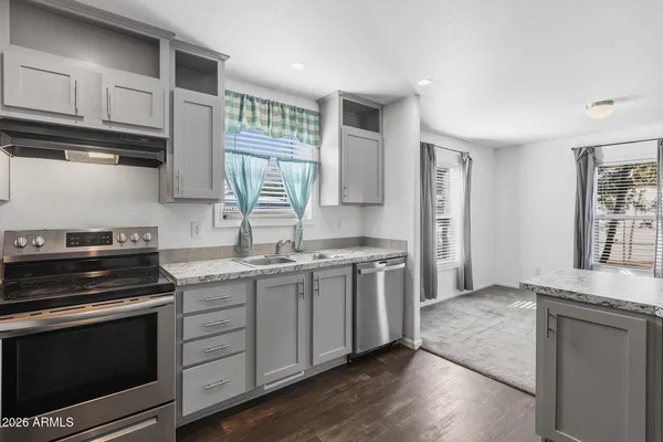 a kitchen with stainless steel appliances granite countertop a stove and a sink