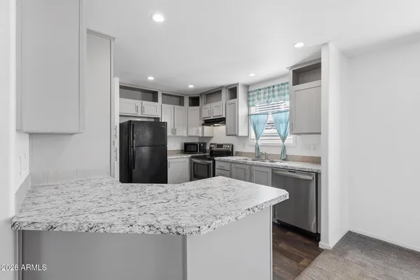 a kitchen with a refrigerator and a sink