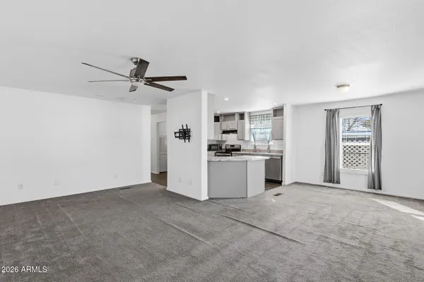 a kitchen with kitchen island granite countertop a sink stainless steel appliances and cabinets