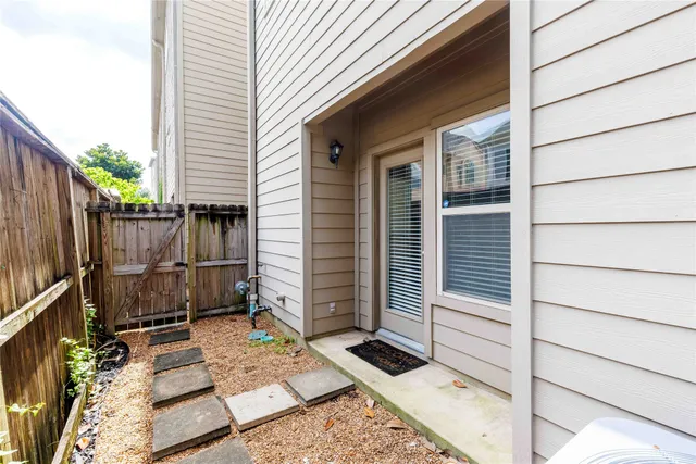 a view of a wooden door and a window
