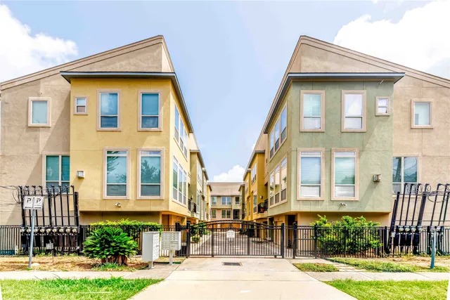 a front view of a residential apartment building with a yard