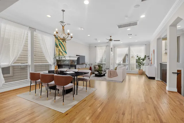 a living room with furniture a fireplace and a chandelier