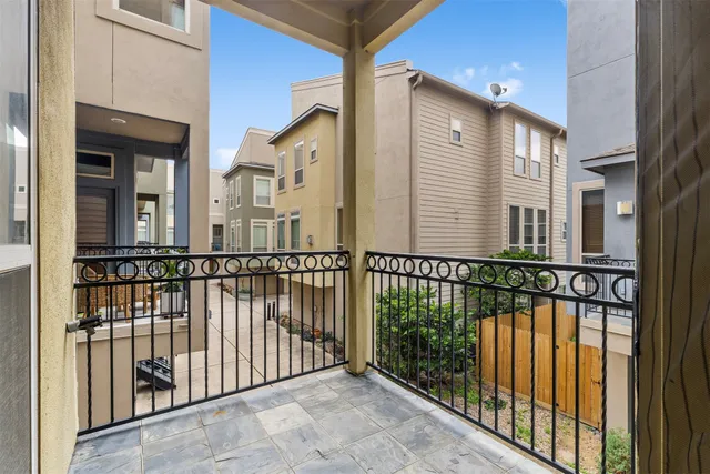 a view of a balcony with a floor to ceiling window and wooden floor