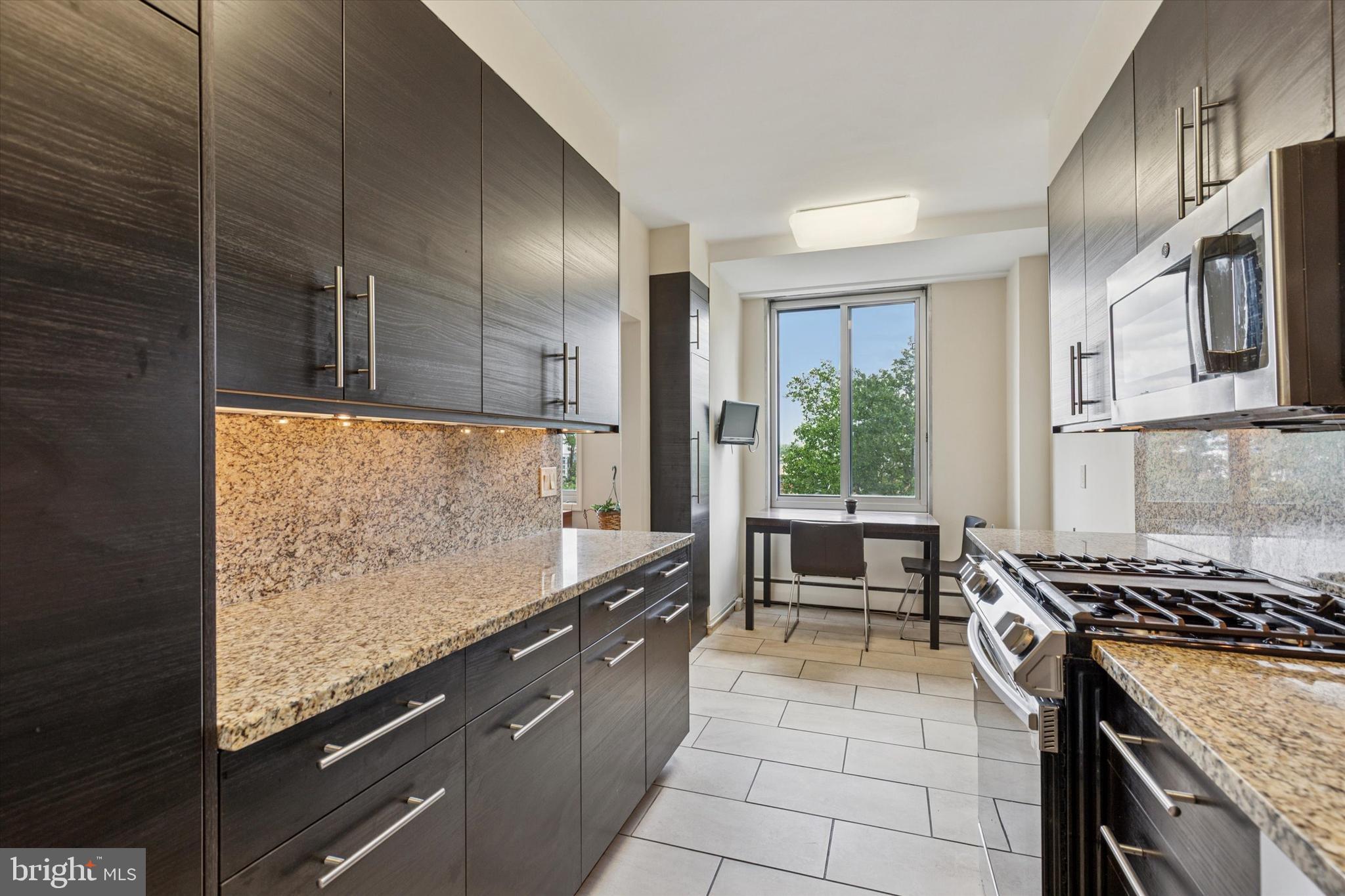 191 Presidential Boulevard, Unit R605 Bala Cynwyd, PA 19004 - Photo 7 of 35 a kitchen with stainless steel appliances granite countertop a stove and a sink