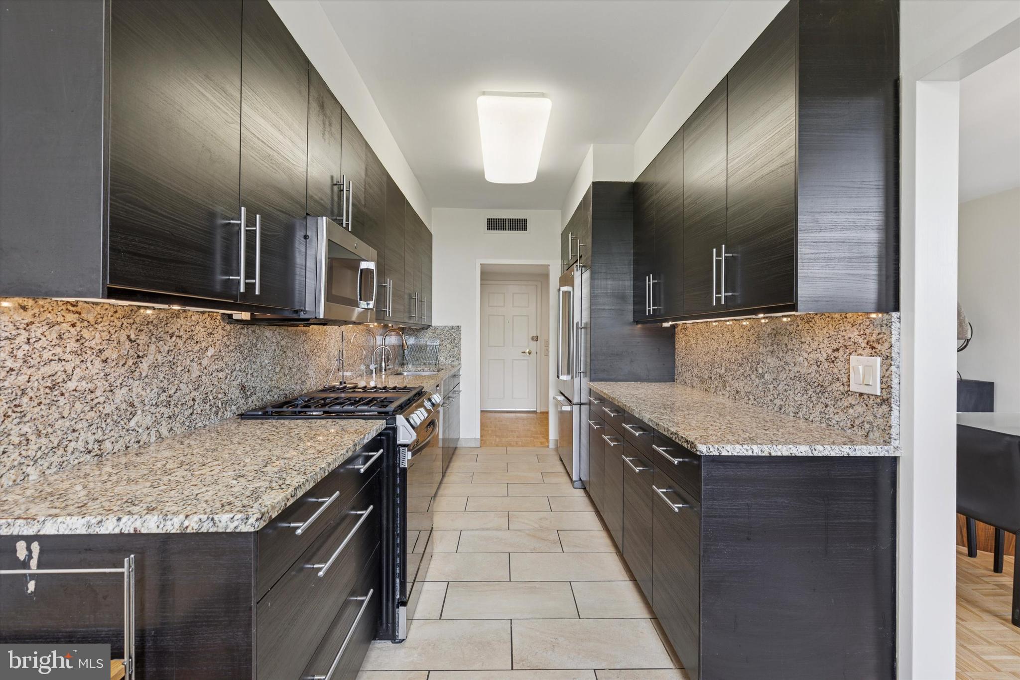 191 Presidential Boulevard, Unit R605 Bala Cynwyd, PA 19004 - Photo 8 of 35 a kitchen with stainless steel appliances granite countertop wooden cabinets and granite counter tops