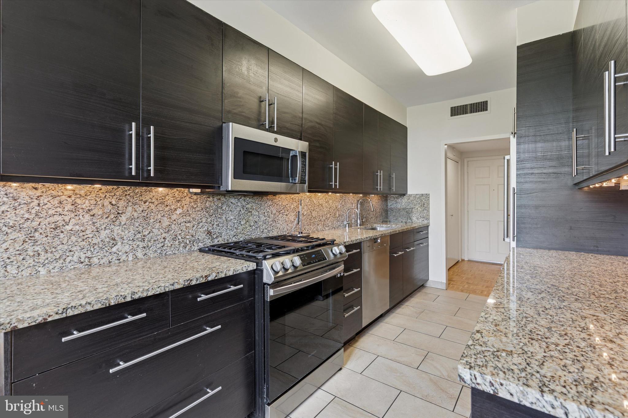 191 Presidential Boulevard, Unit R605 Bala Cynwyd, PA 19004 - Photo 9 of 35 a kitchen with granite countertop cabinets stainless steel appliances and counter space
