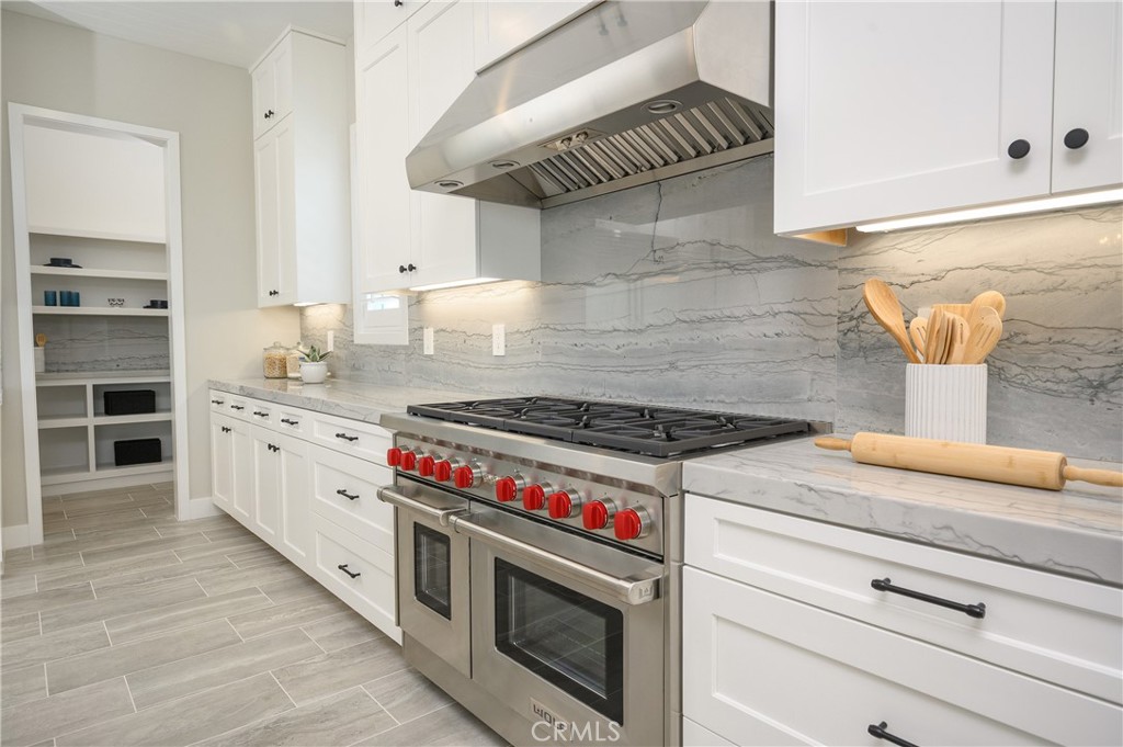 13093 Edgware Drive Rancho Cucamonga, CA 91739 - Photo 4 of 25 a kitchen with granite countertop a stove and a sink