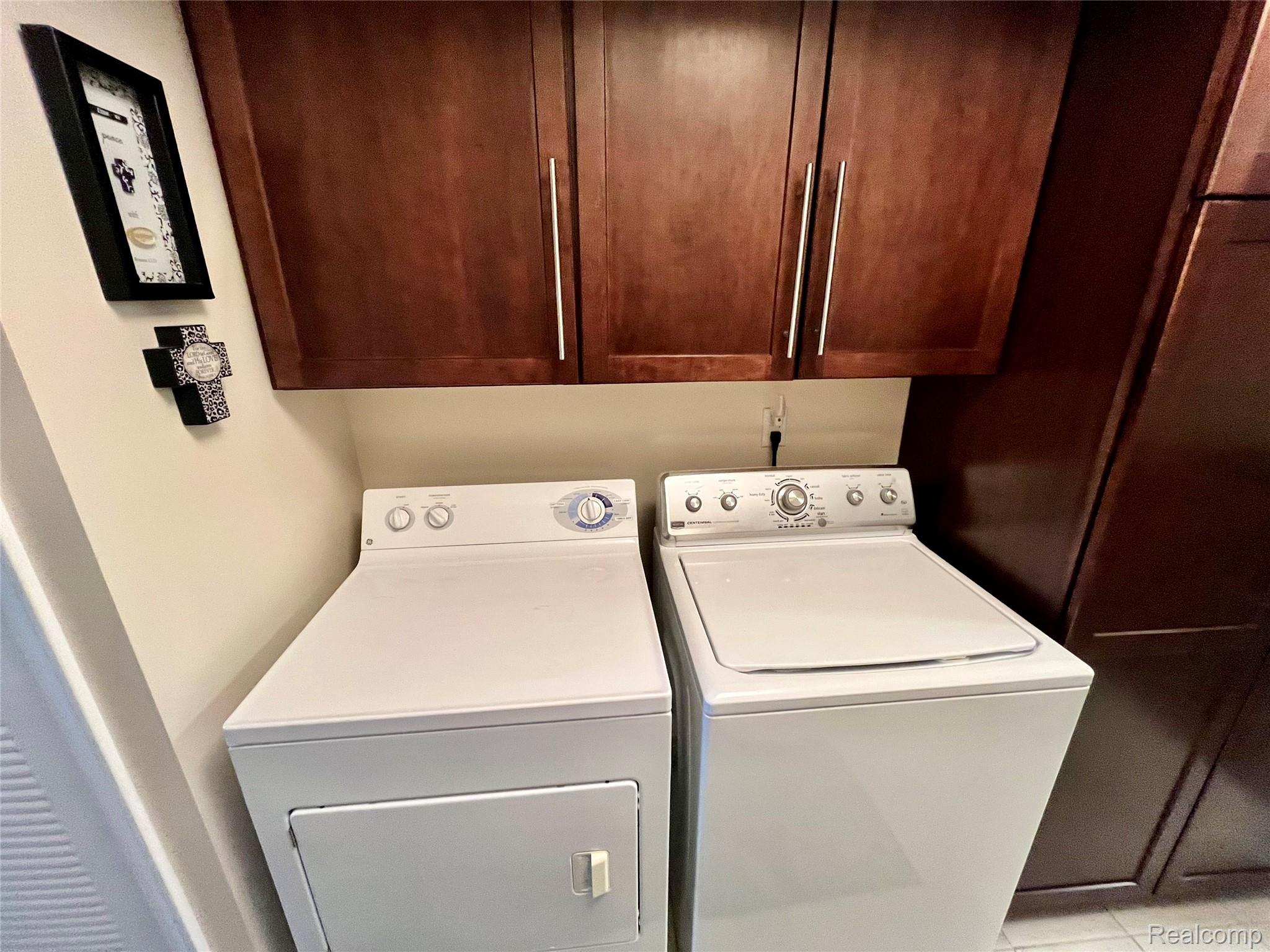 3624 Oakmonte Boulevard, Unit 82 Rochester, MI 48306 - Photo 26 of 37 Laundry room with independent washer and dryer and cabinet space