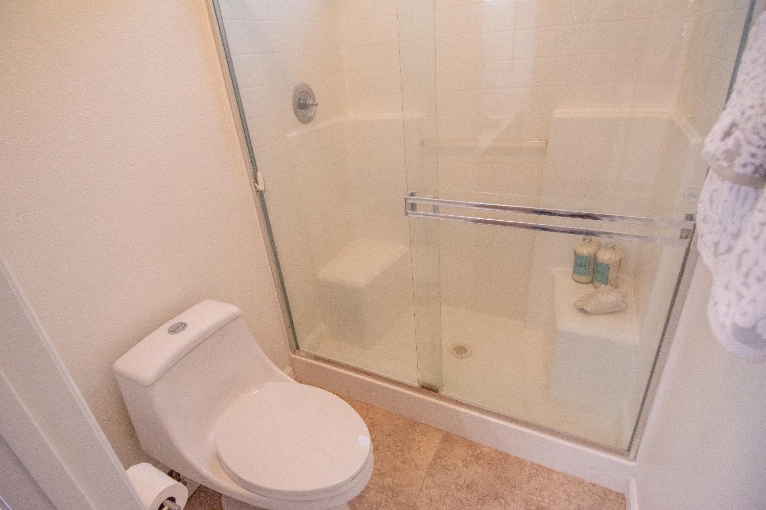 105 Whiting Way Folsom, CA 95630 - Photo 29 of 78 a white toilet sitting next to a shower