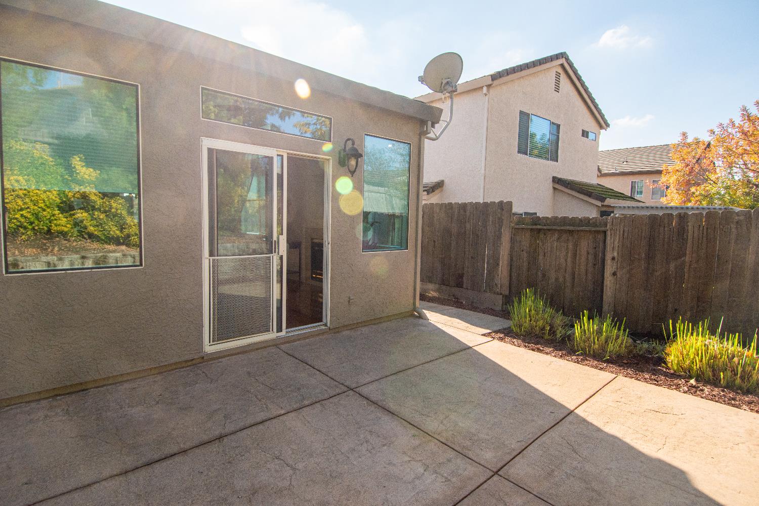 105 Whiting Way Folsom, CA 95630 - Photo 52 of 78 a view of backyard with potted plants and wooden fence