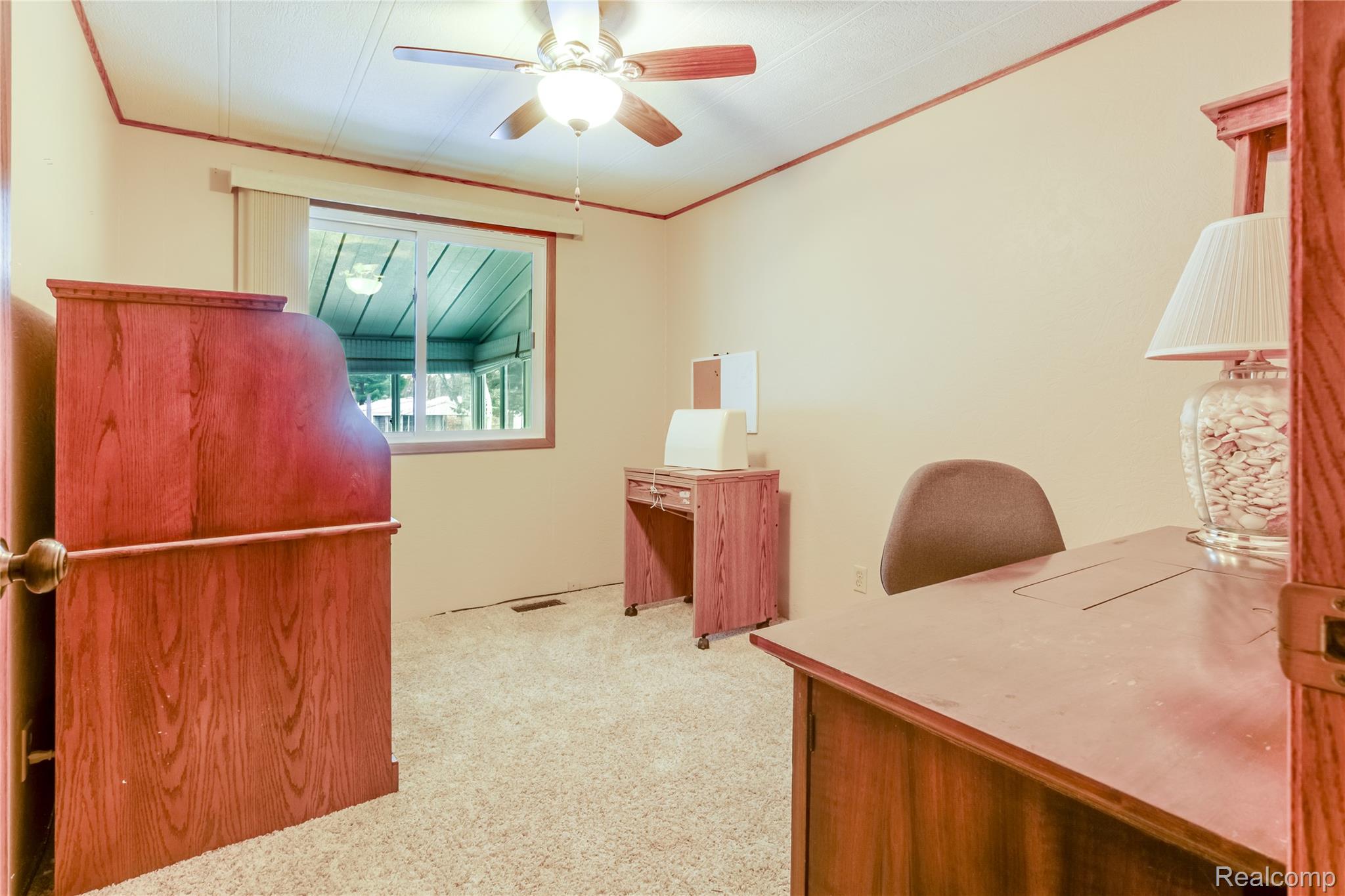3333 Ravenswood Road Marysville, MI 48040 - Photo 17 of 25 Office space featuring light carpet, a ceiling fan, and crown molding