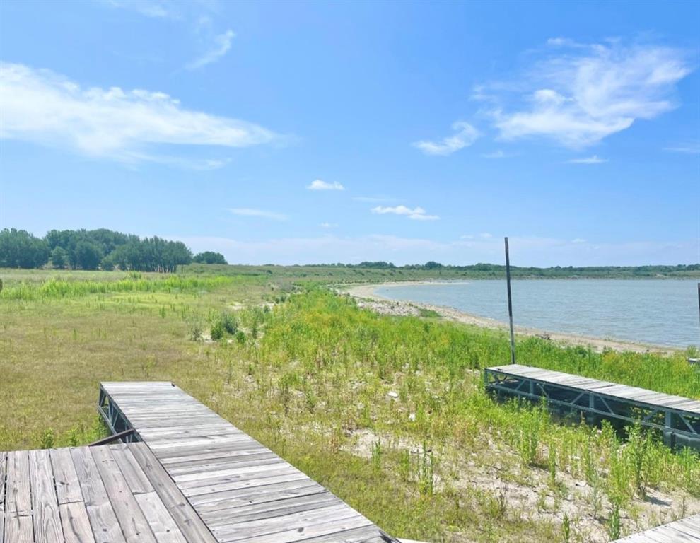 Lot 59 Comanche Lake Road Comanche, TX 76442 - Photo 6 of 6 a view of a lake with a big yard