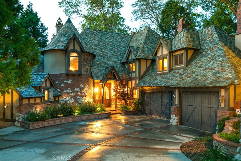 a front view of a house with a garden
