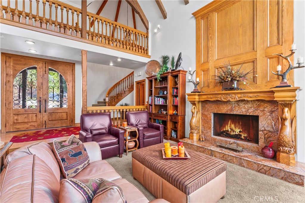 145 Pheasant Run Lake Arrowhead, CA 92352 - Photo 11 of 65 a living room with furniture a fireplace and a large window