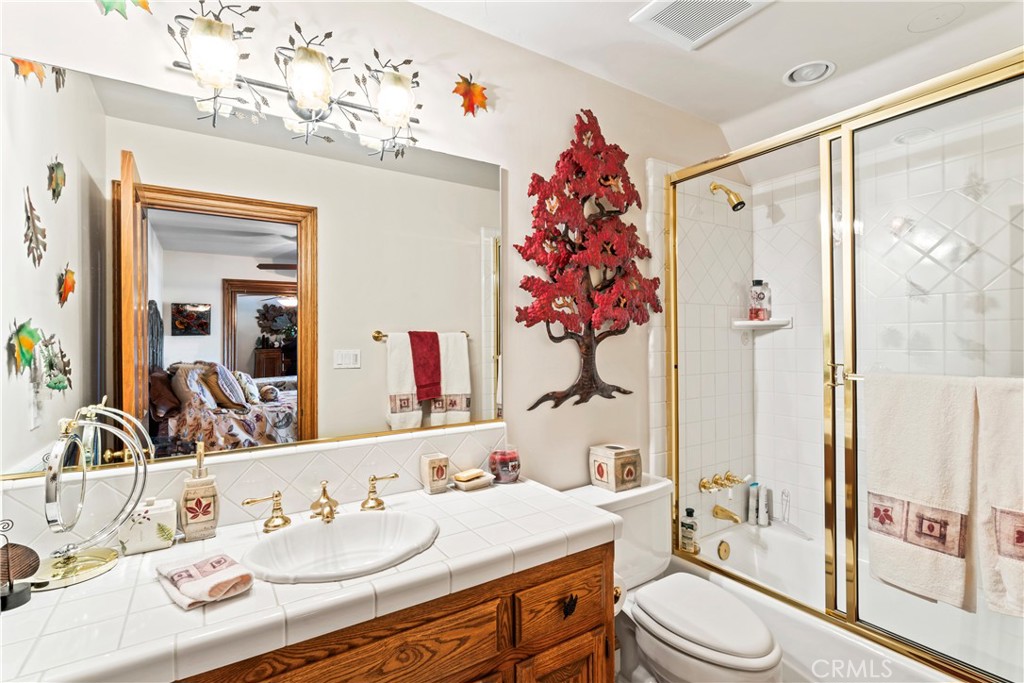 145 Pheasant Run Lake Arrowhead, CA 92352 - Photo 40 of 65 a bathroom with a sink a toilet and shower